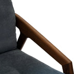 Close-up of Walnutry solid black walnut lounge chair armrest with dark gray fabric upholstery