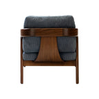 Walnutry solid black walnut lounge chair with dark wood frame and gray cushioned upholstery viewed from the back