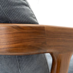 Close-up of solid black walnut lounge chair backrest crafted by Walnutry with smooth wood grain