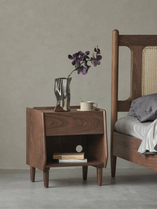 Front view of Walnutry solid black walnut nightstand featuring rich wood grain and mid-century modern tapered legs.