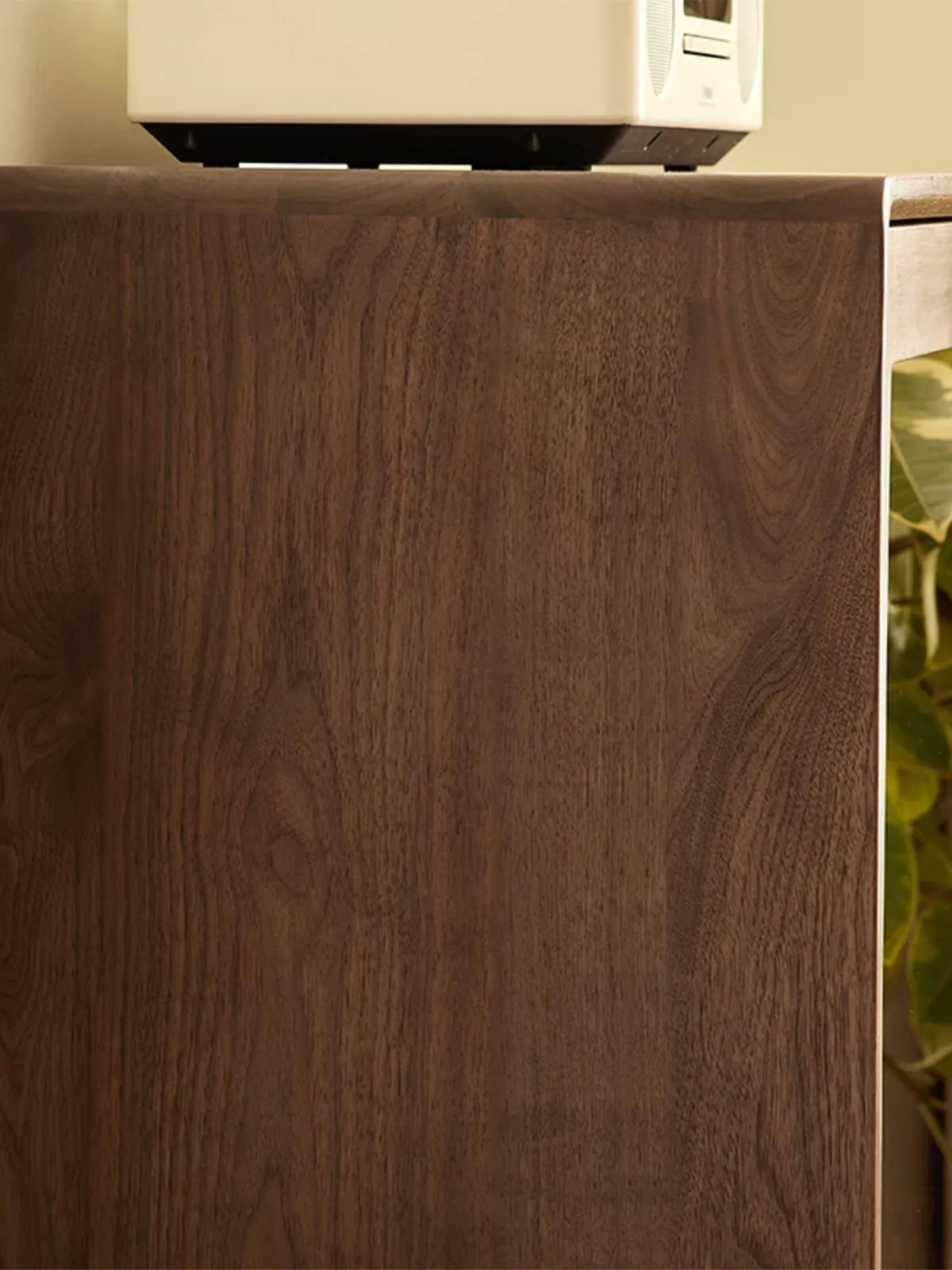 Close-up of FAS grade North American black walnut wood grain on the side panel of the Kurumi cabinet.

