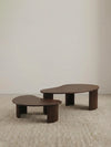 "Studio isolation shot of the Walnutry Kurumi solid wood nesting table set on a neutral background."
