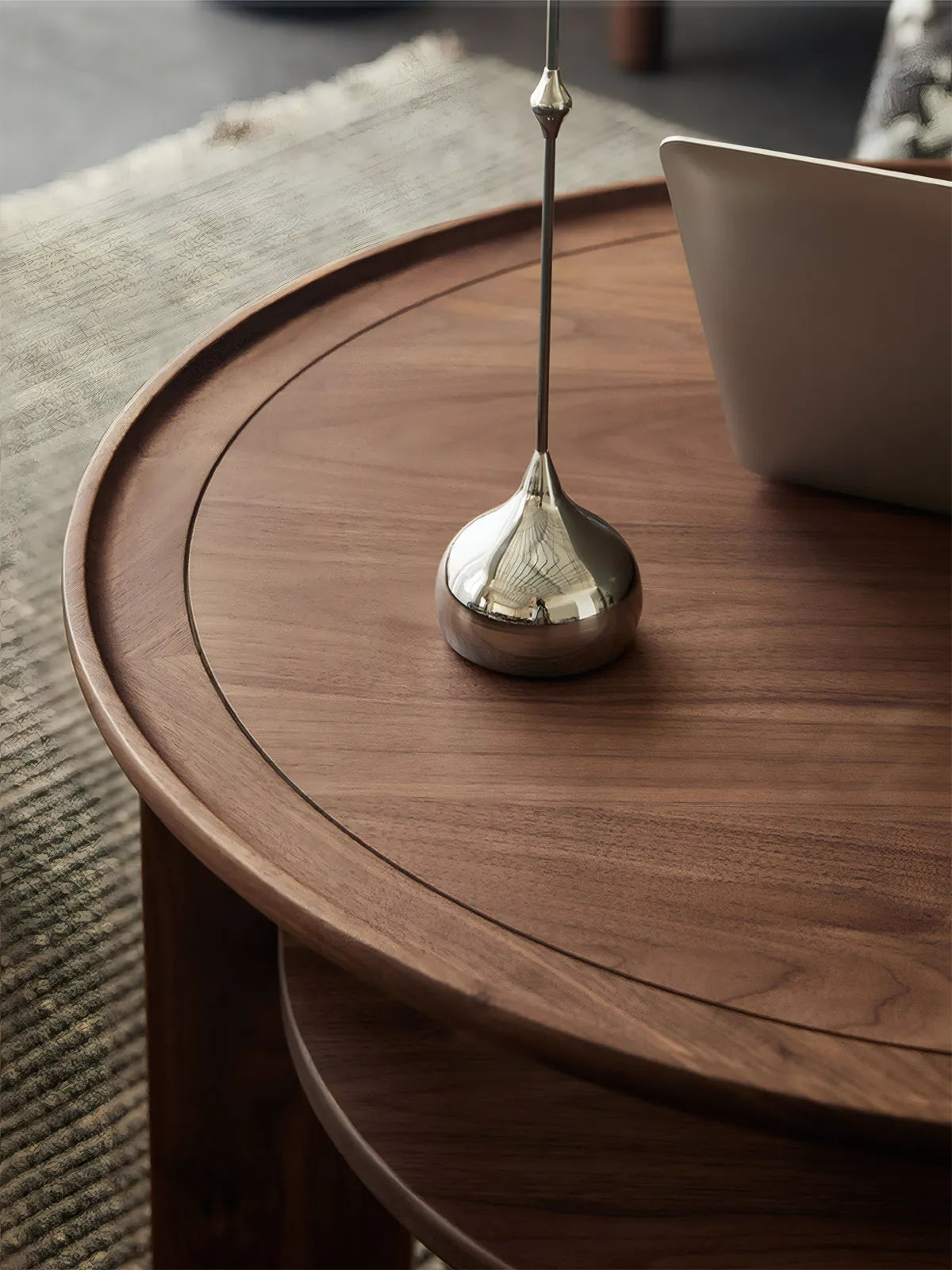 Close-up of solid North American black walnut coffee table top showing raised rim detail and natural wood grain texture.