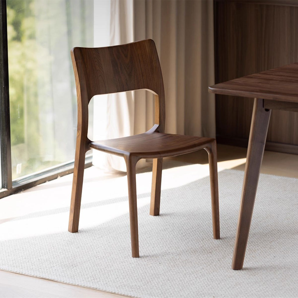Walnutry Contour solid black walnut dining chair with ergonomic curved backrest.