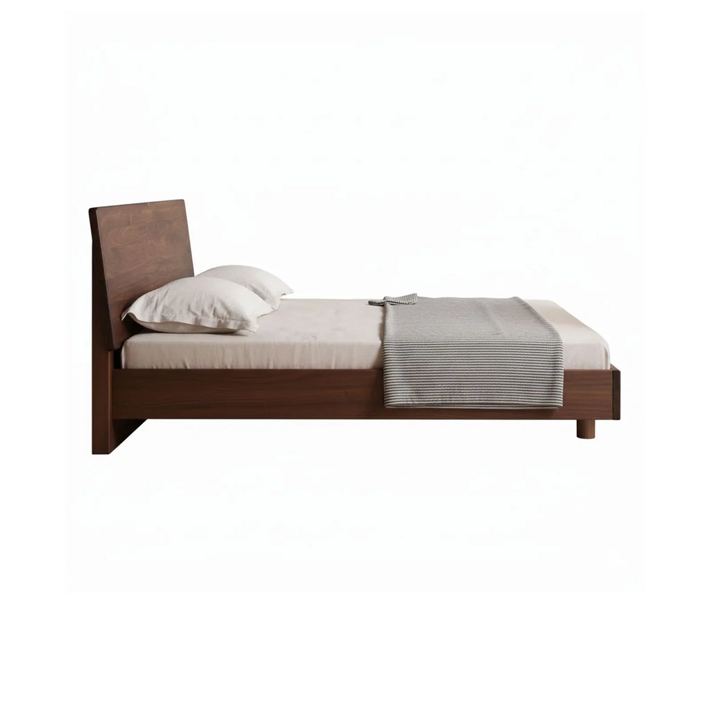 Solid walnut queen floating bed frame side view with beige bedding and gray throw