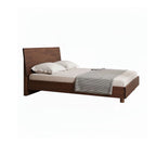 Queen solid walnut floating bed frame with beige bedding and gray striped throw