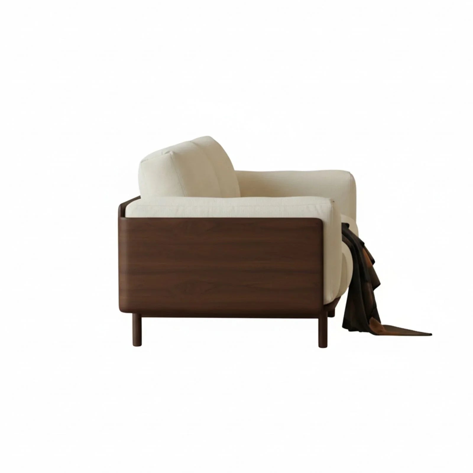 Side view of modern solid walnut sofa with cream fabric upholstery and draped dark brown throw