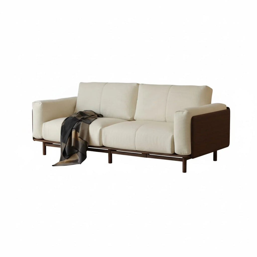 Modern solid walnut sofa with beige fabric upholstery and a patterned black and brown throw blanket