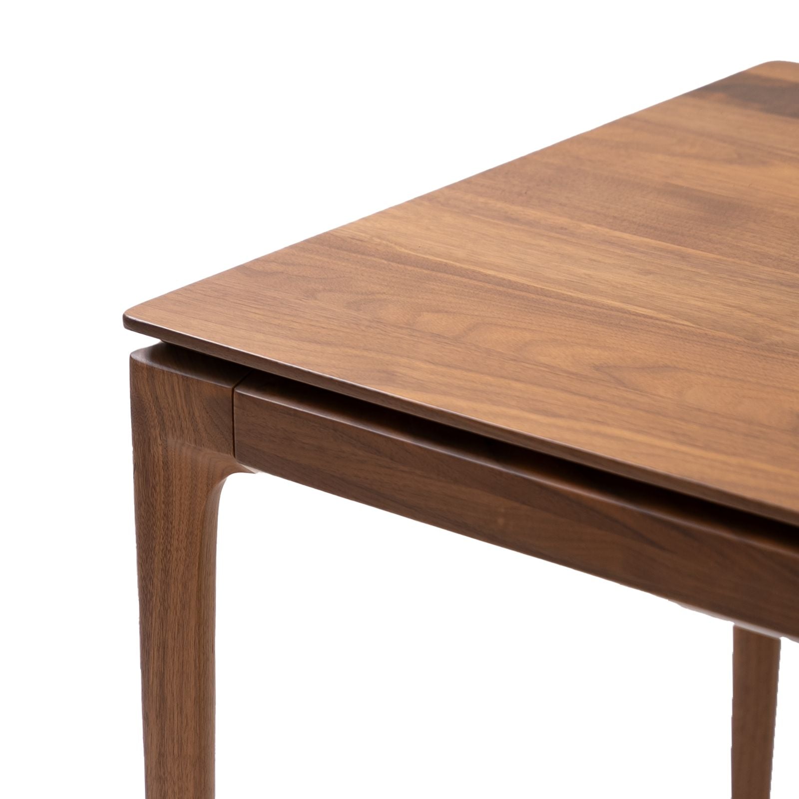 Close-up of Walnutry solid walnut table corner showcasing smooth wood grain and craftsmanship