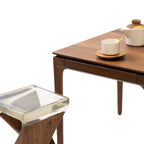 Walnutry solid walnut table with sleek wooden legs and a tea set on top showcasing fine craftsmanship