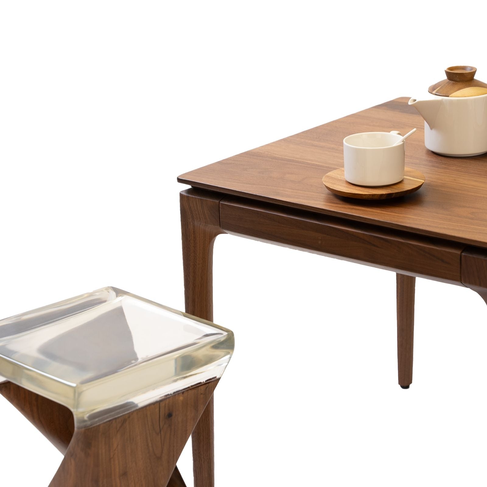 Walnutry solid walnut table with sleek wooden legs and a tea set on top showcasing fine craftsmanship