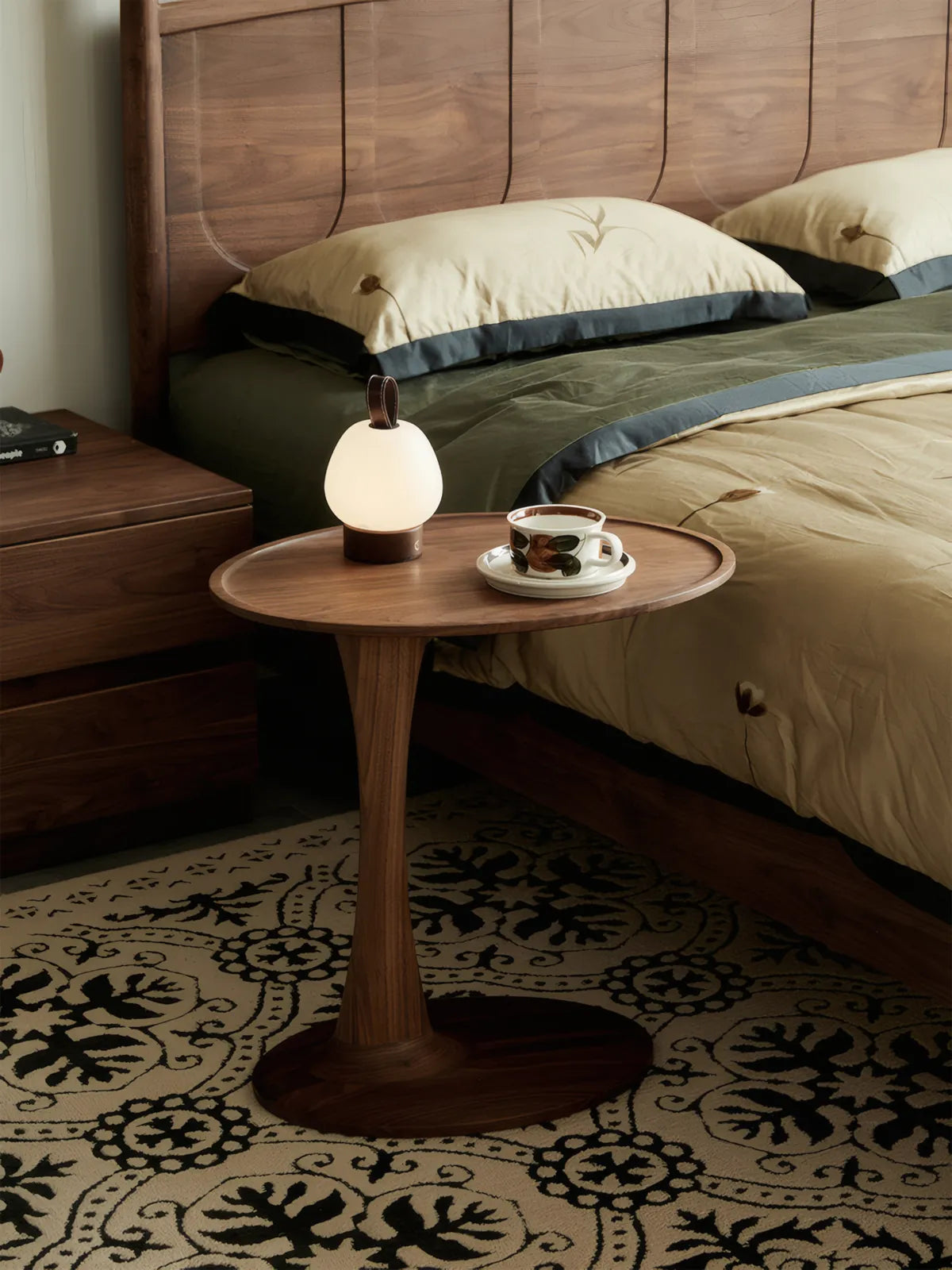 The Orbit side table paired with a matching walnut bed frame, creating a cohesive and luxurious solid wood bedroom suite.