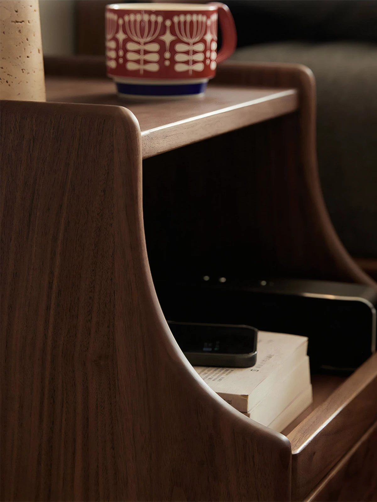 Side profile of Vantana nightstand highlighting the organic curved wood design and solid walnut construction.