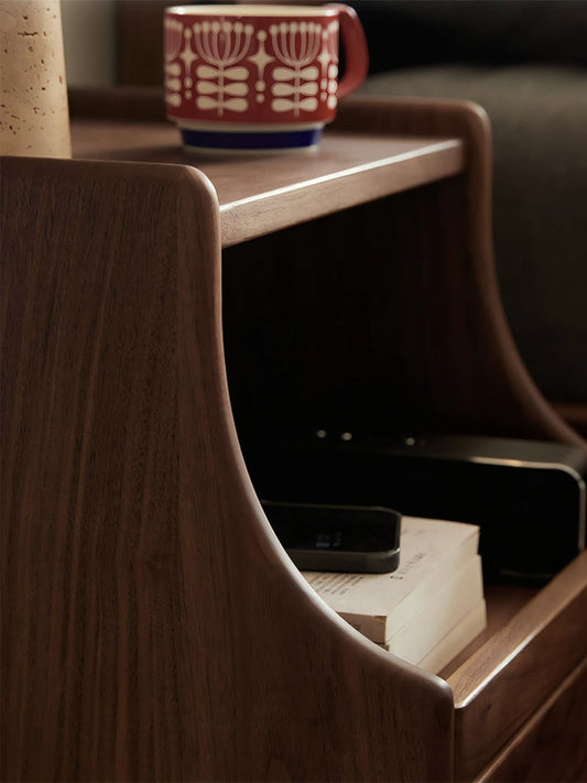 Side profile of Vantana nightstand highlighting the organic curved wood design and solid walnut construction.