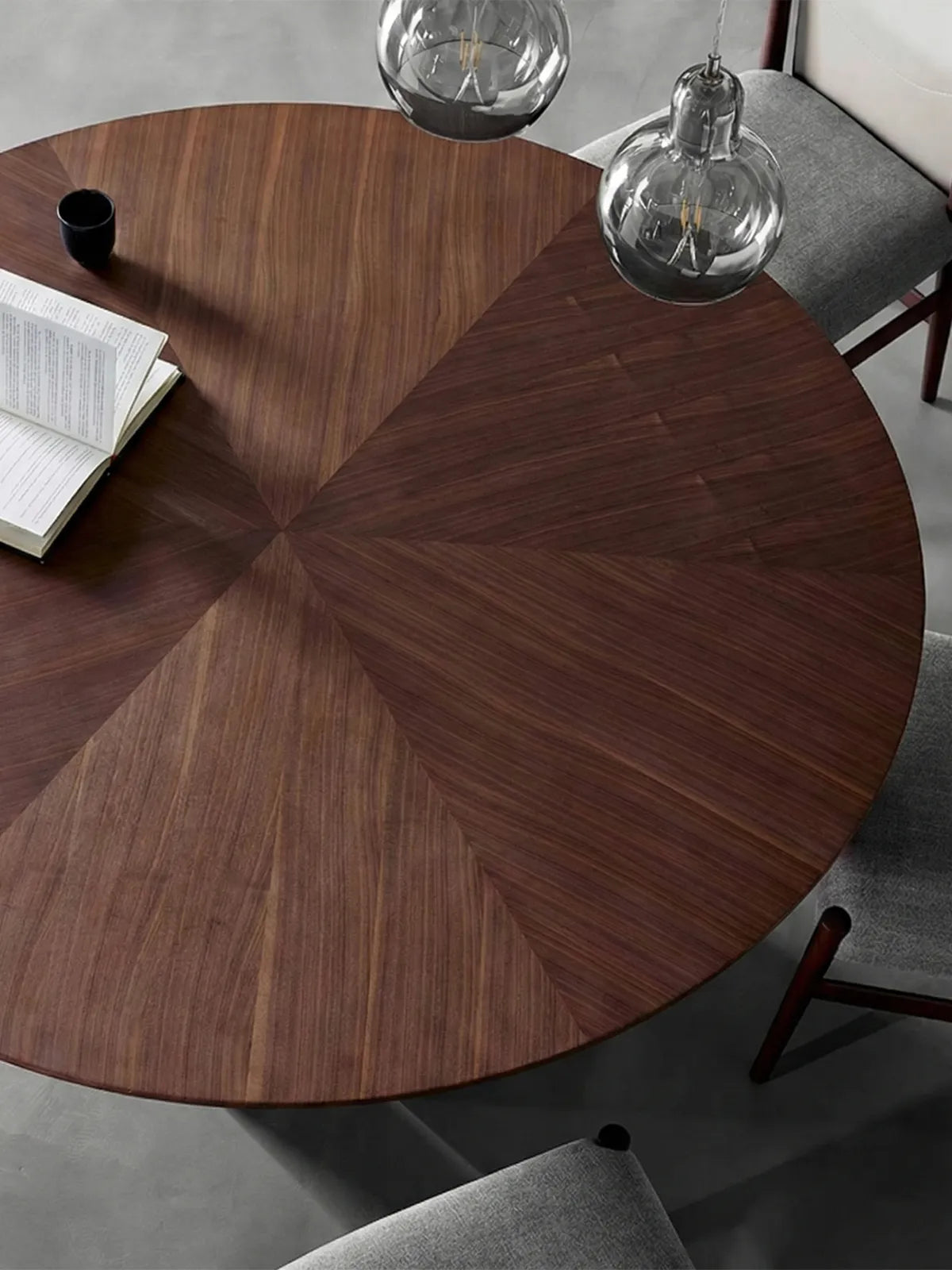 Close up top view of Kurumi dining table showing the solid wood radial match sunburst grain pattern of black walnut heartwood.

