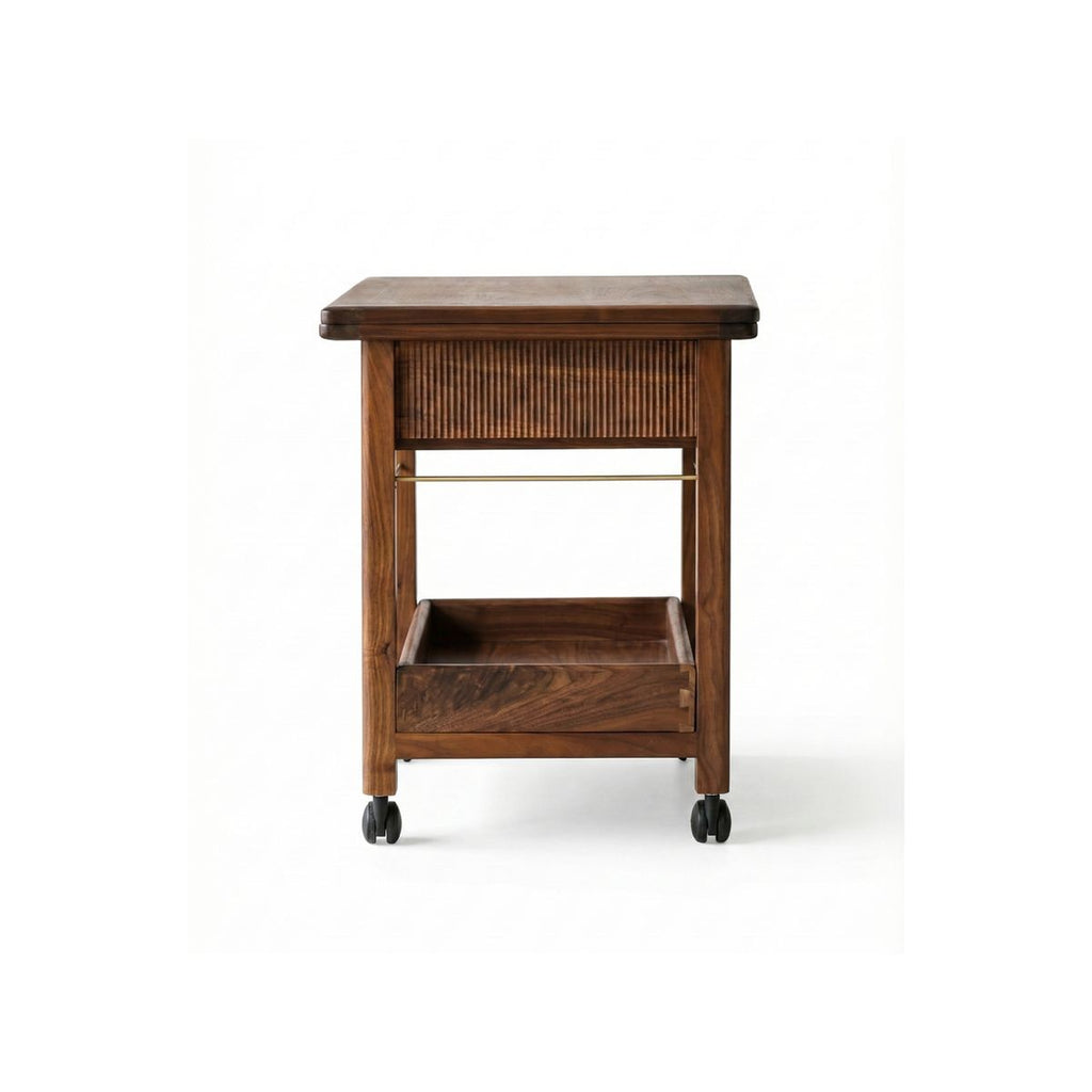 Studio shot of the solid walnut rolling cart with open storage shelves and caster wheels.