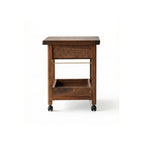 Studio shot of the solid walnut rolling cart with open storage shelves and caster wheels.