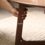 Detail of the sturdy tapered solid wood legs and rounded edge craftsmanship.