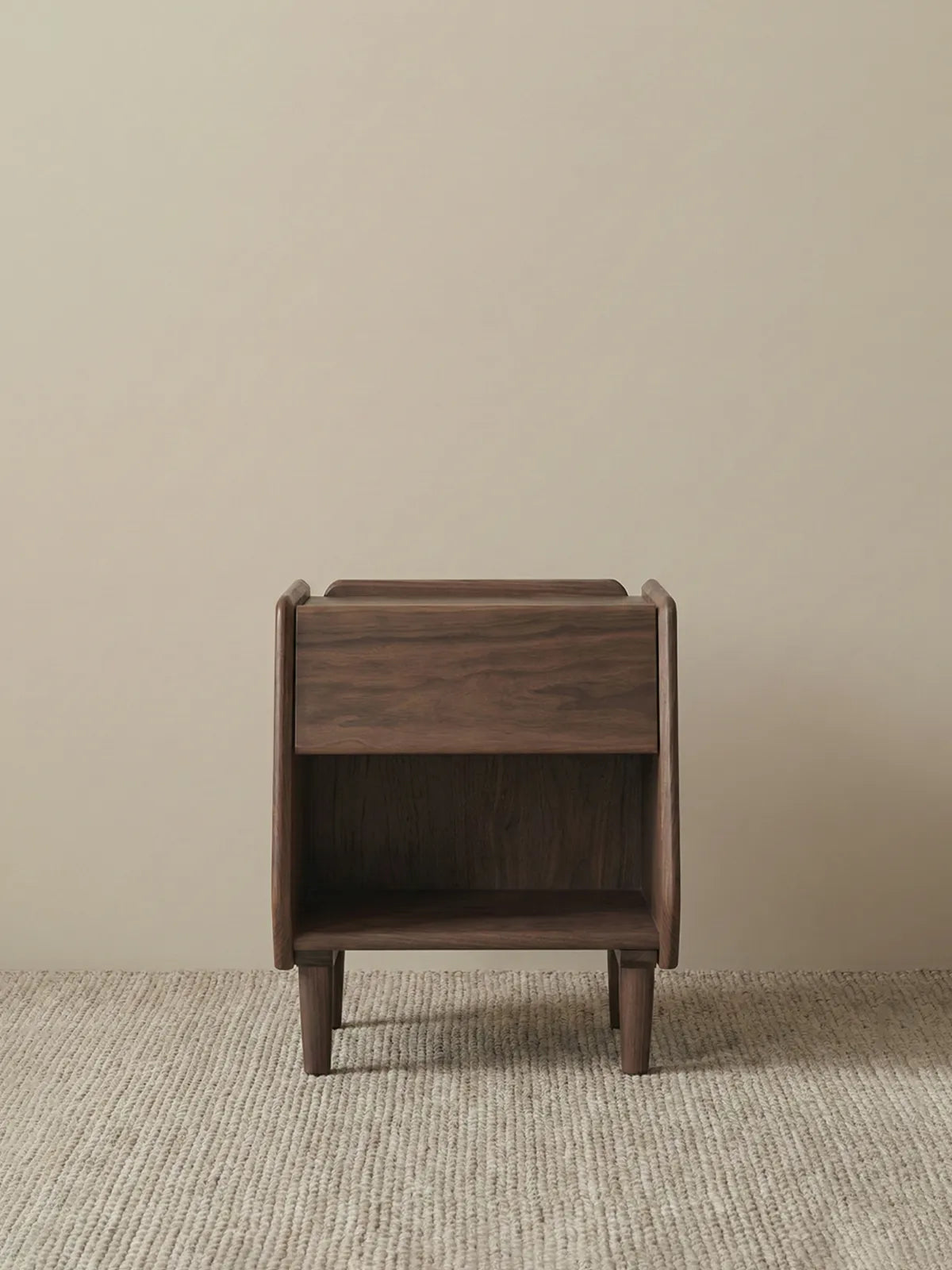 Detail view of solid walnut tapered legs with floor protectors, highlighting structural stability.