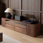 Sturdy solid wood TV stand supporting a large flat-screen TV, showcasing the strength and stability of North American walnut.