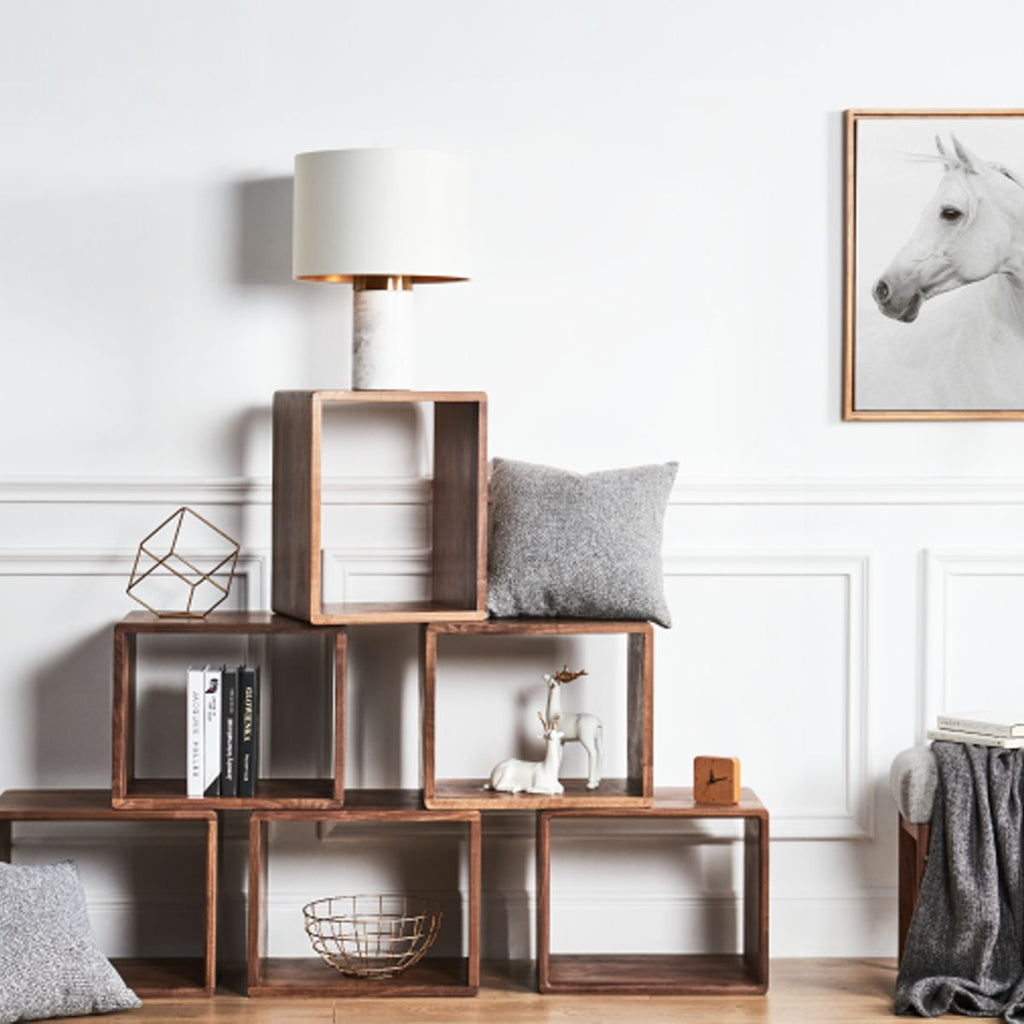 Living room wall featuring a custom arrangement of stacked solid wood storage cubes.