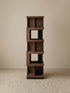 Studio shot of the empty Walnutry Suiseki rotating bookshelf showing the sculptural form and solid wood construction.