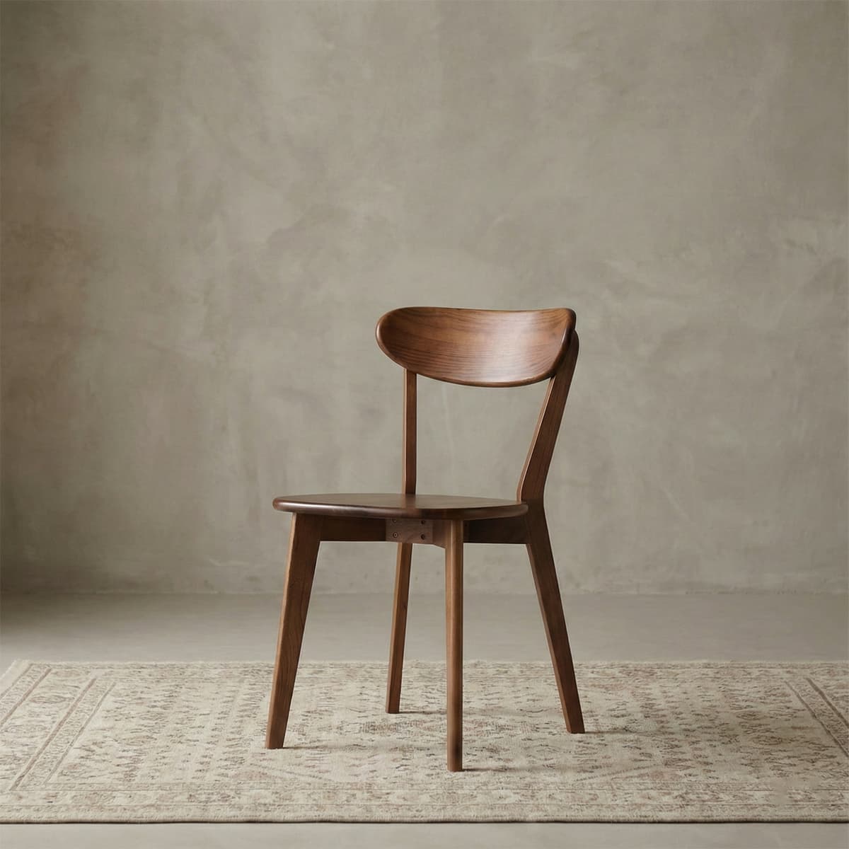 Studio shot of the Sylva chair in North American Black Walnut, isolated on a neutral background.