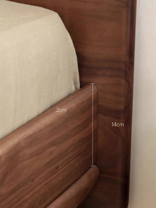 Detailed shot of the bed frame corner construction showing the 2cm mattress inset and 14cm side rail height.