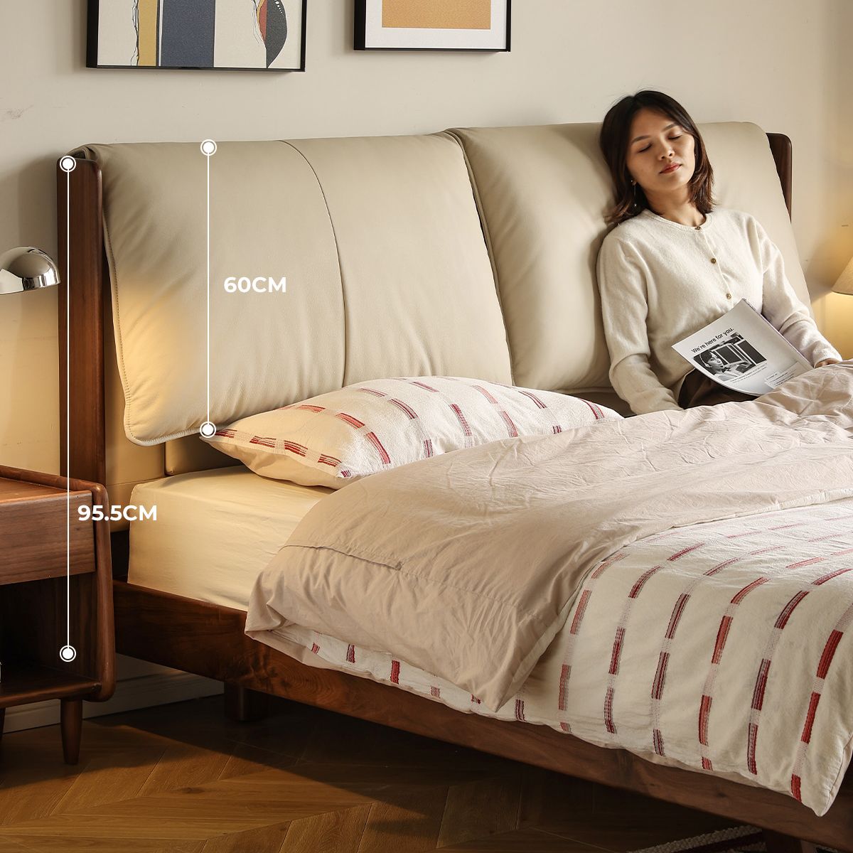 Cream leather upholstered bed headboard with wooden frame, woman leaning against it reading