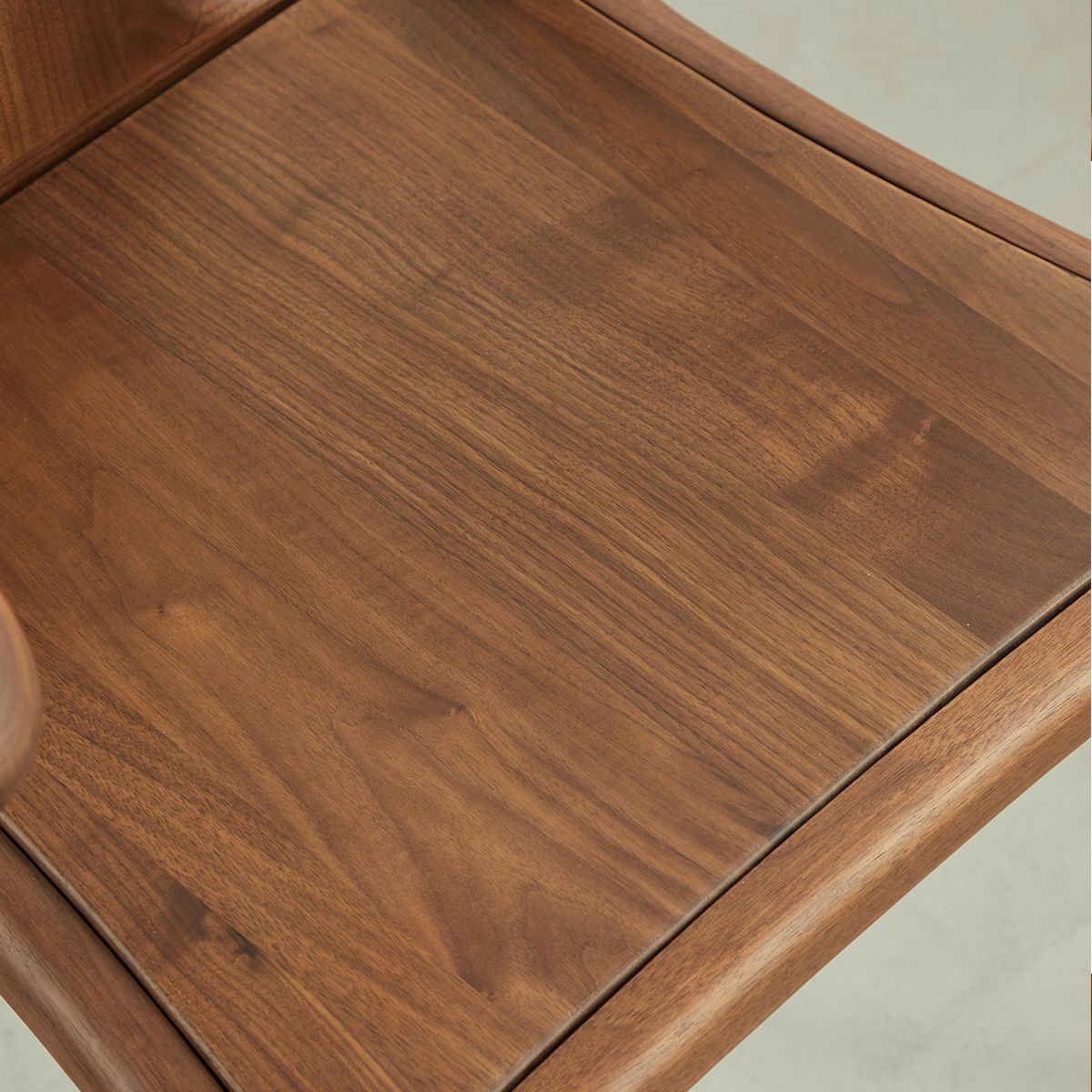 Close-up of smooth top grain lumber wooden chair seat with natural wood grain texture