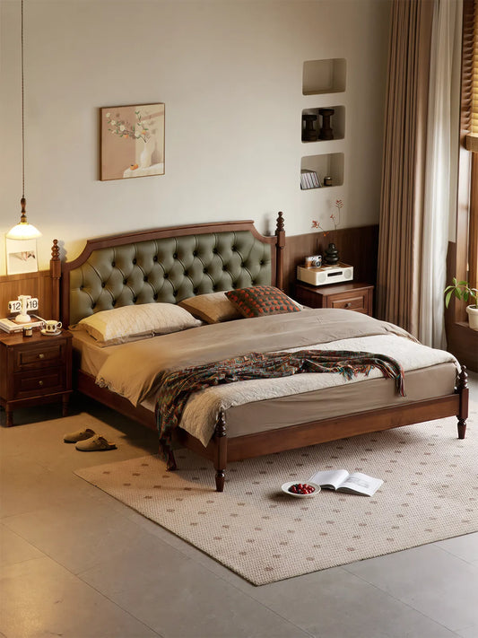 Low angle view of turned solid walnut legs on the Kurumi platform bed frame.