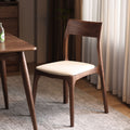 Walnutry Comfort solid black walnut dining chair with malt white leather upholstery.