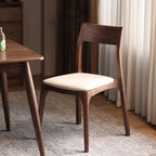 Walnutry Comfort solid black walnut dining chair with malt white leather upholstery.