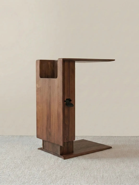 Detail view of the vertical storage compartment built into the walnut table column.