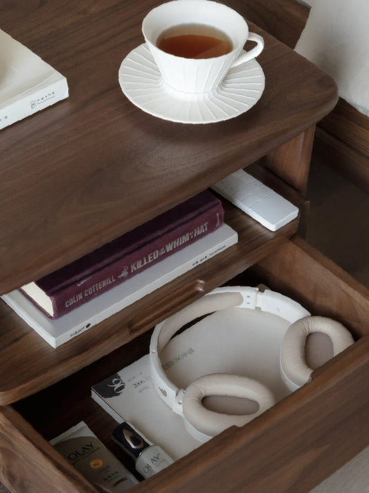 Front elevation of walnut bedside table showing spacious storage drawer and natural wood grain patterns.