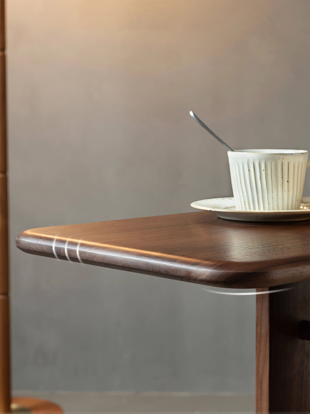 Close-up of solid walnut wood edge details on the Meridian table, highlighting the premium matte oil finish and natural timber texture.