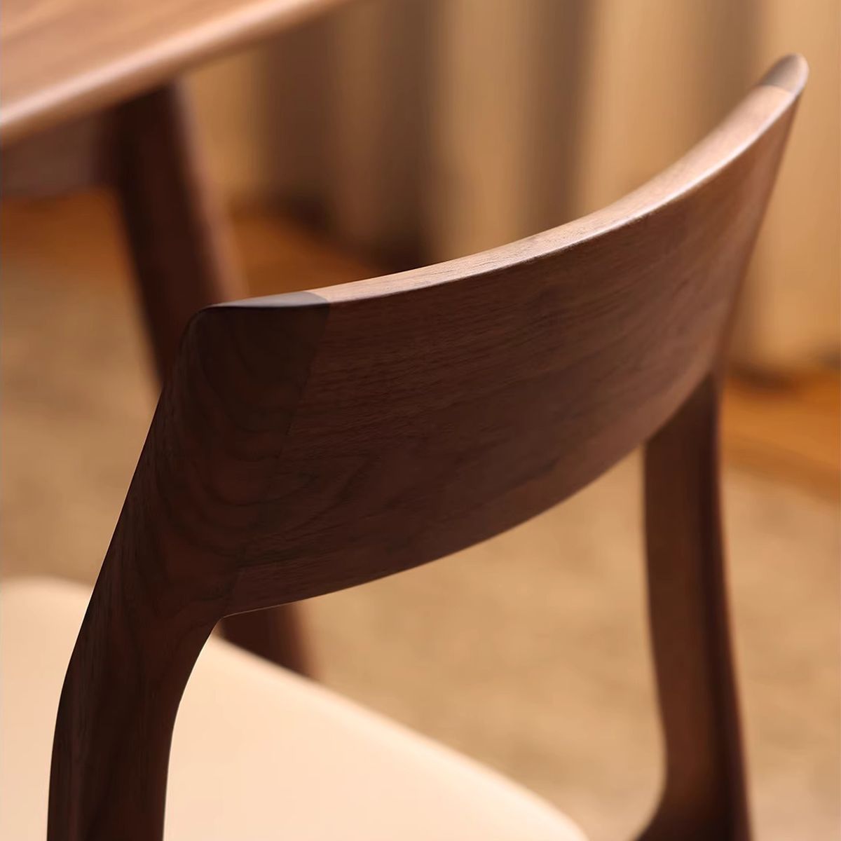 Back view of the dining chair highlighting the solid north american black walnut frame construction.