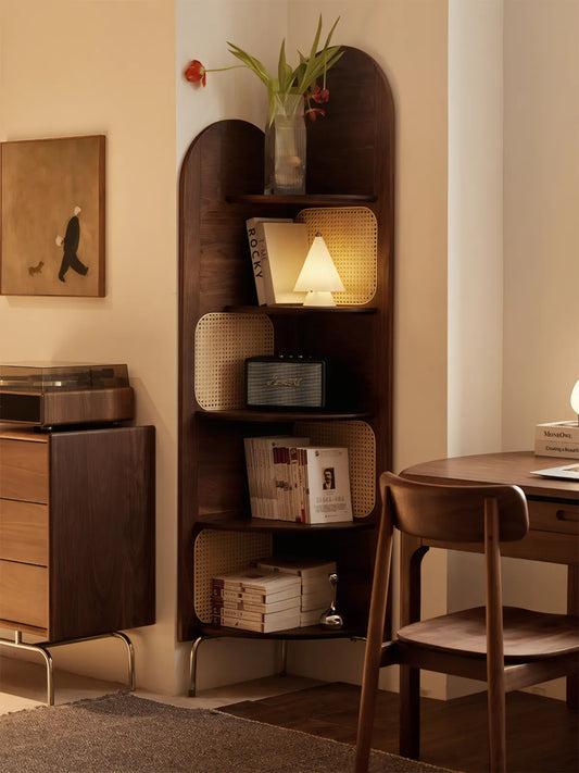 Walnutry Heritage corner stand illuminated by a warm table lamp, displaying vinyl records and books in a cozy evening setting.