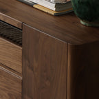 Side profile of walnut media cabinet with smooth finish, books, and ceramic vase on top