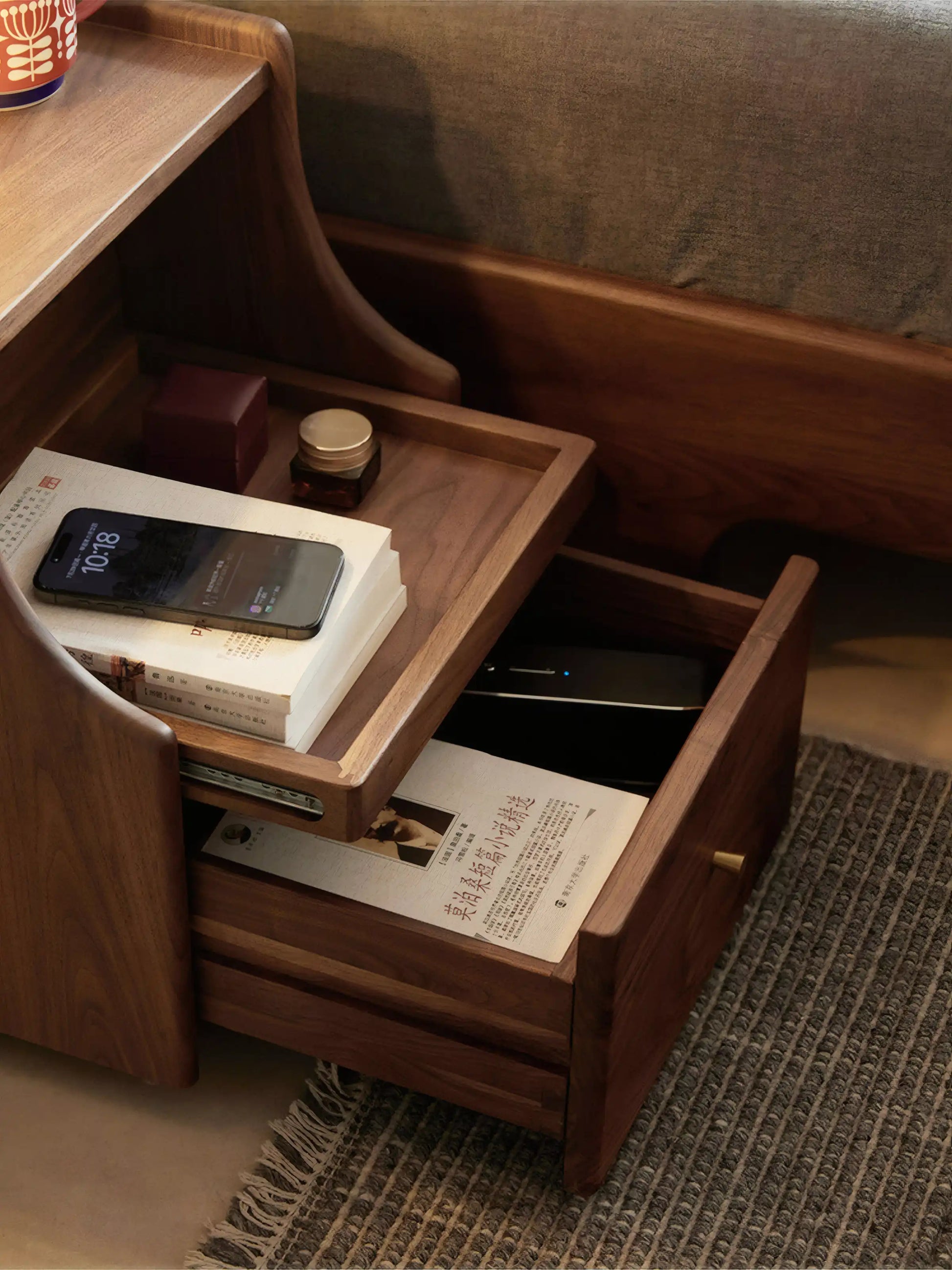 Close-up of open drawer and shelf on solid walnut nightstand, showing rich wood grain and storage utility.