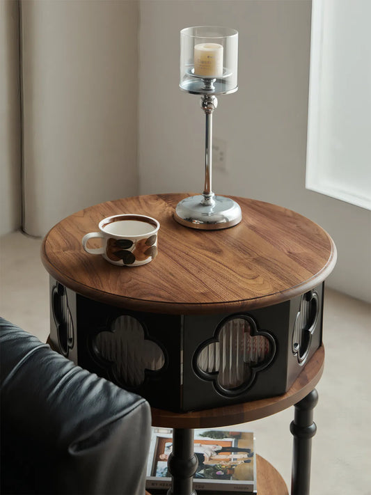 Top view of Sylvan solid walnut round nightstand with coffee cup and candle, showing rich wood grain.