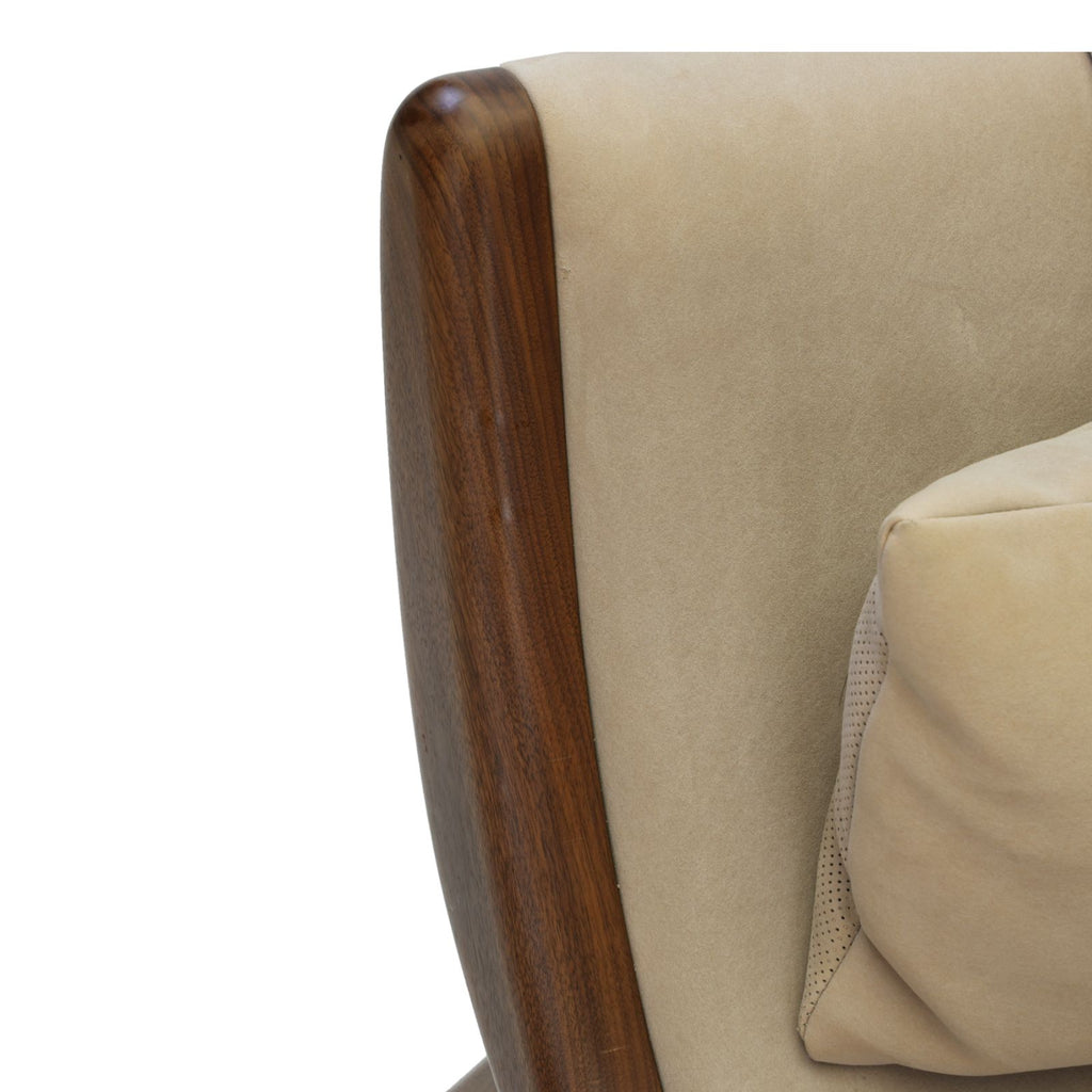 Close-up of walnut sculptural chaise lounge showing curved walnut wood frame and beige upholstery