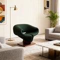 Walnut sculptural lounge chair with dark green upholstery and wooden base in modern living room