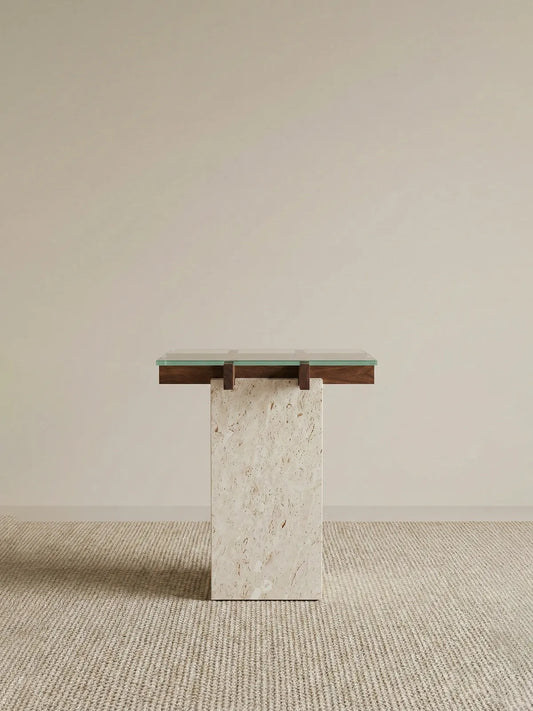 Walnutry Cumberland side table with solid walnut frame and honed travertine base in a minimal studio setting.