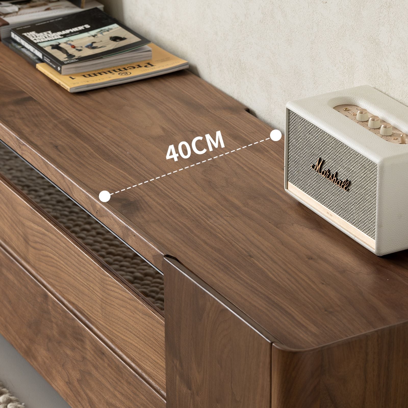 Walnut wood cabinet top with 40cm size label, holding a white Marshall speaker and stacked books