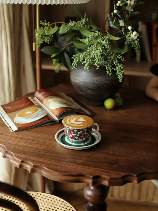 Detail shot of the matte oil finish on black walnut wood grain featuring a latte cup and open book.
