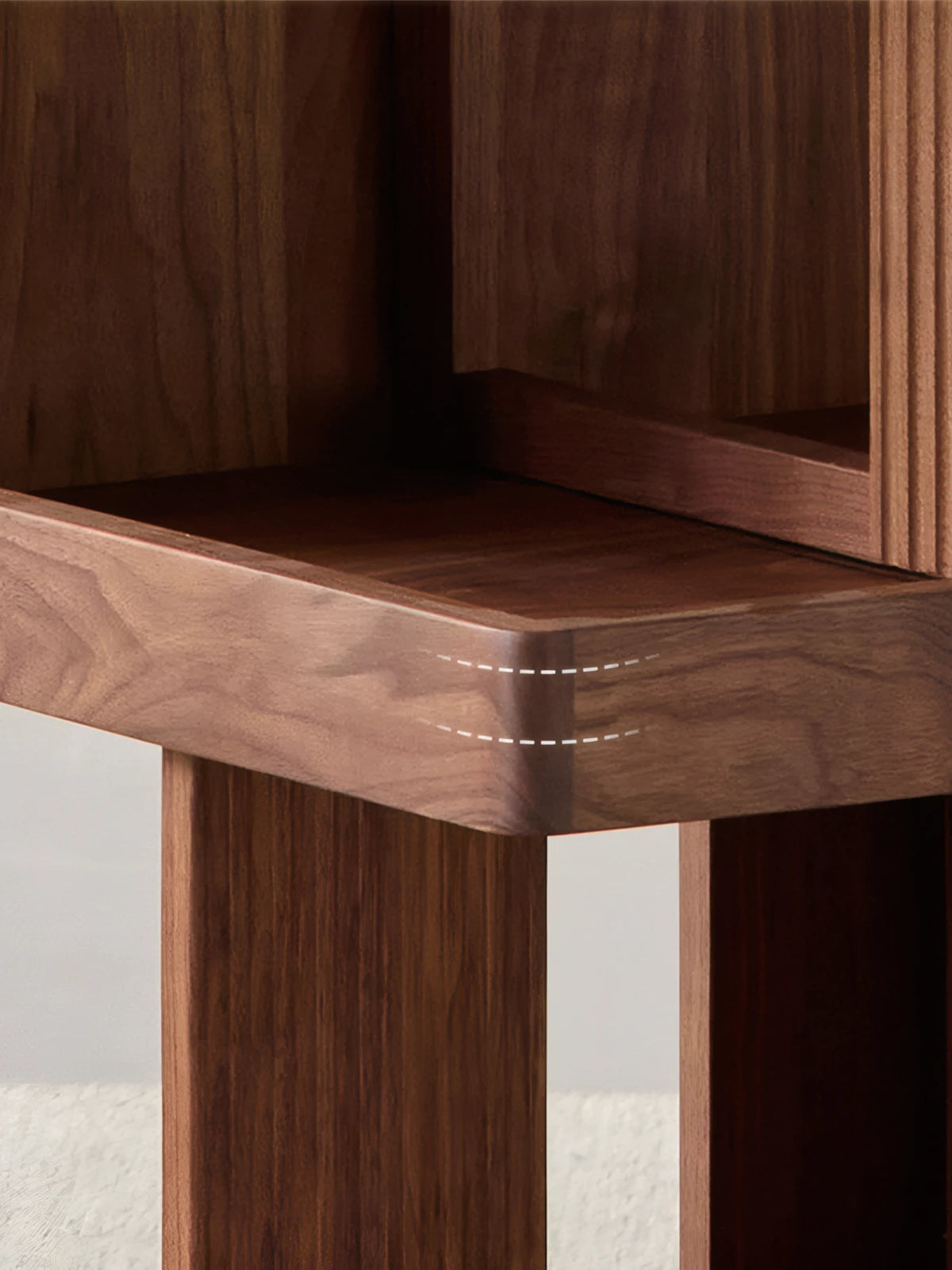 Close up detail of the rounded edges and seamless joinery on the North American black walnut shelves.