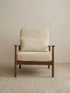 Walnutry Alden Armchair front view with neutral fabric cushions, lumbar pillow, walnut frame, and balanced proportions for living room or bedroom placement