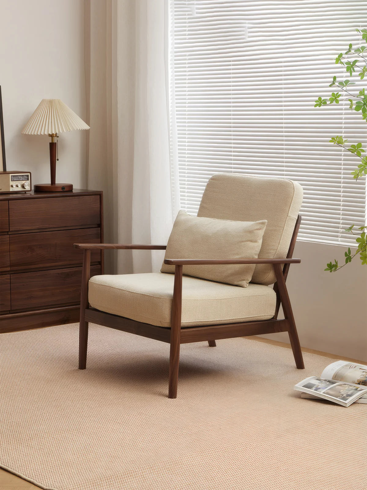 Walnutry Alden Armchair lifestyle main image showing a mid-century inspired fabric armchair with walnut frame styled beside a cabinet and window