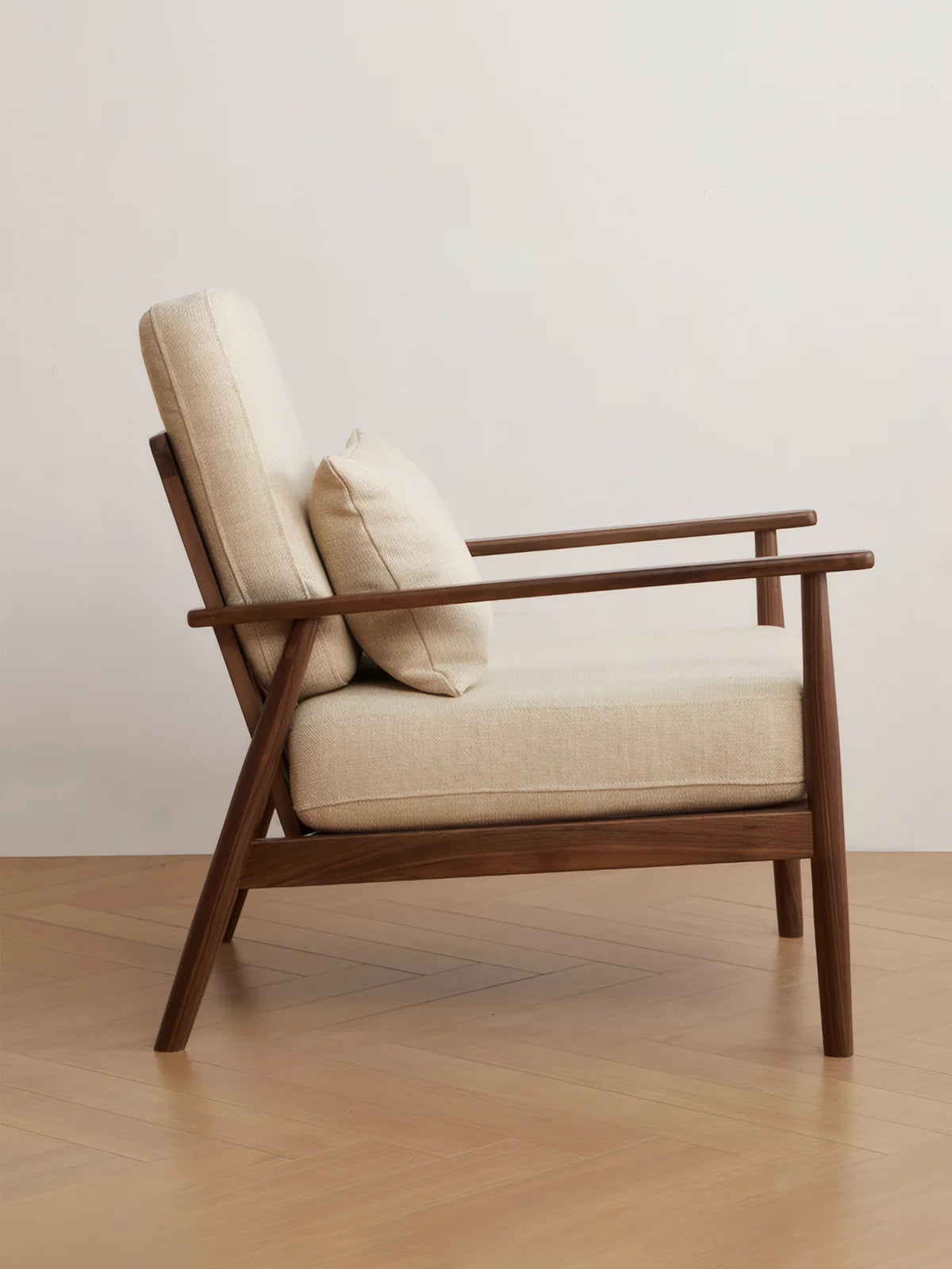 Walnutry Alden Armchair side profile showing gently reclined back, supportive upholstered seat, slim wood armrests, and mid century armchair wood silhouette